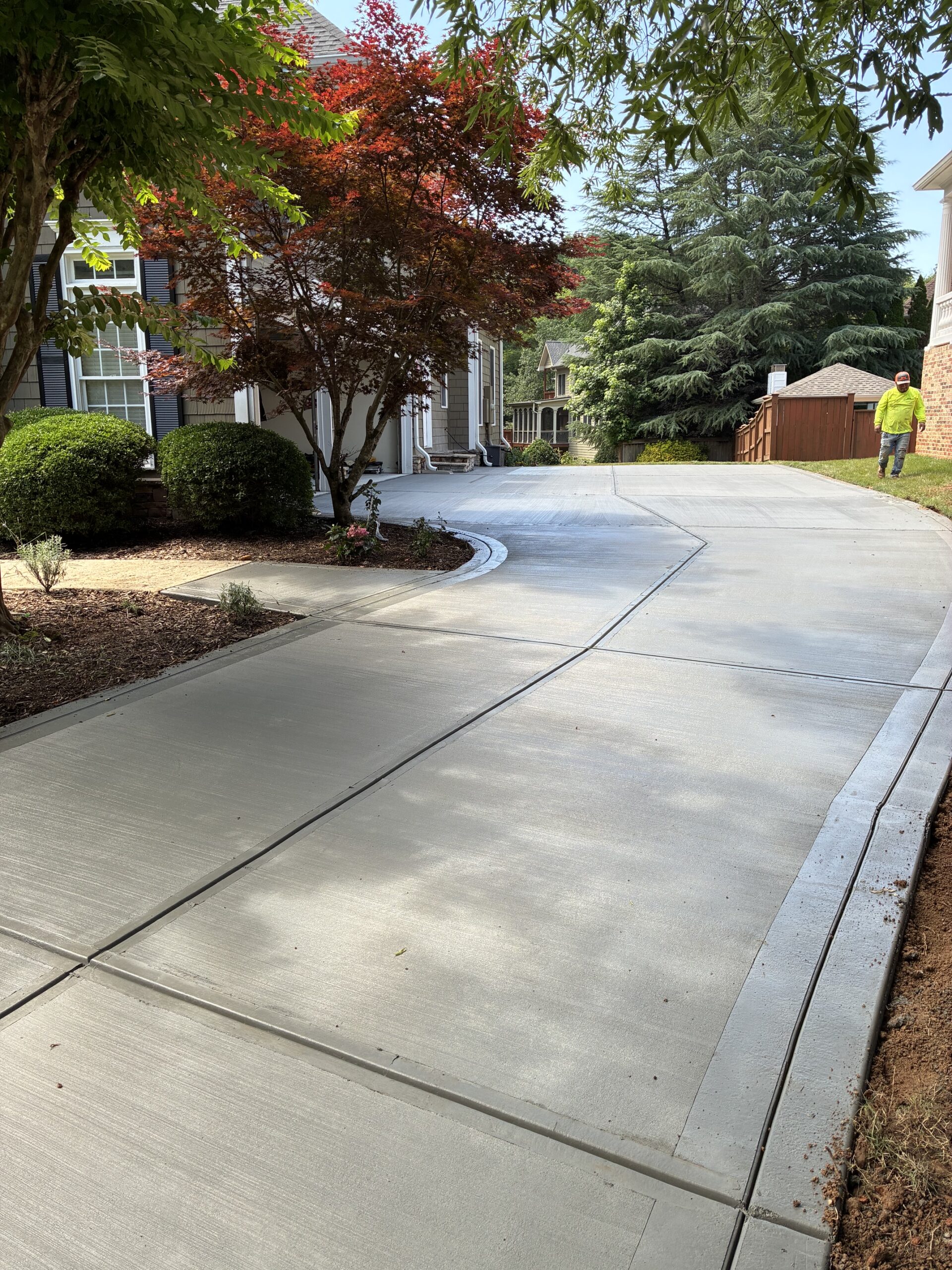 Residential concrete driveway replacement with curved design and clean finish in Marietta, Georgia.